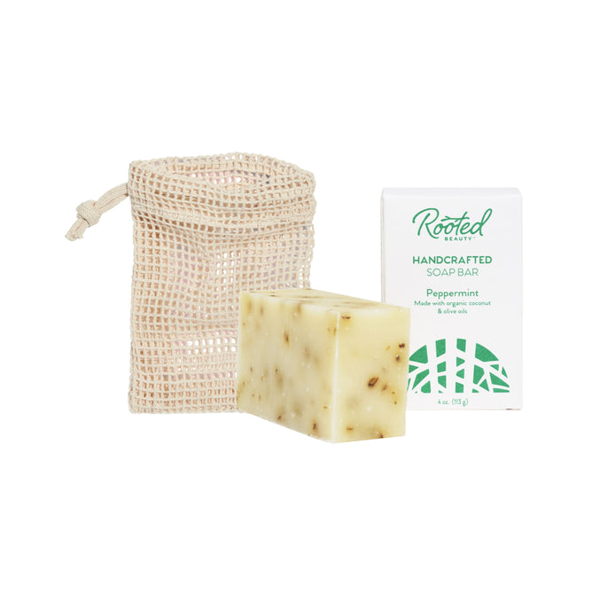 The Grove Collaborative Bar Soap + Saver Bag Duo features a handcrafted peppermint soap bar with natural fragments, displayed in front of its box beside a beige mesh drawstring pouch.
