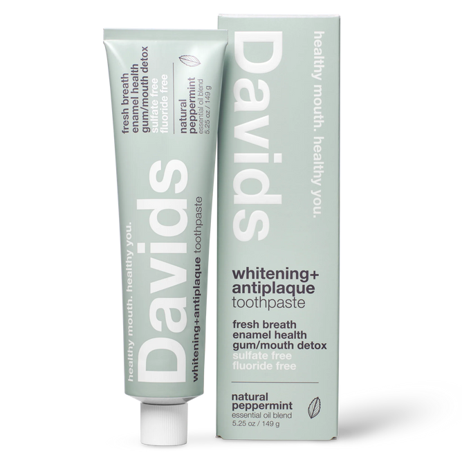 A tube and box of Davids Premium Toothpaste - Whitening + Antiplaque in natural peppermint flavor, designed with a minimalist light green look and white text showcasing features such as fluoride-free formula, support for enamel health, and EWG Verified natural whitening.