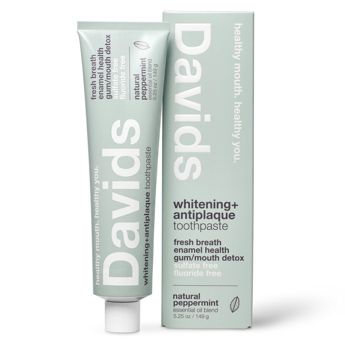 A tube and box of Davids Premium Toothpaste - Whitening + Antiplaque in natural peppermint flavor, designed with a minimalist light green look and white text showcasing features such as fluoride-free formula, support for enamel health, and EWG Verified natural whitening.