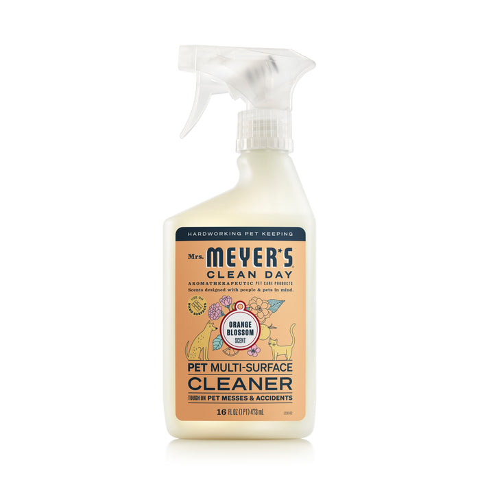 Mrs. Meyers Pet Multi-Surface Cleaner, with a spray nozzle and odor-neutralizing orange blossom scent, features playful dog and cat illustrations on the label for tackling tough pet messes effortlessly.