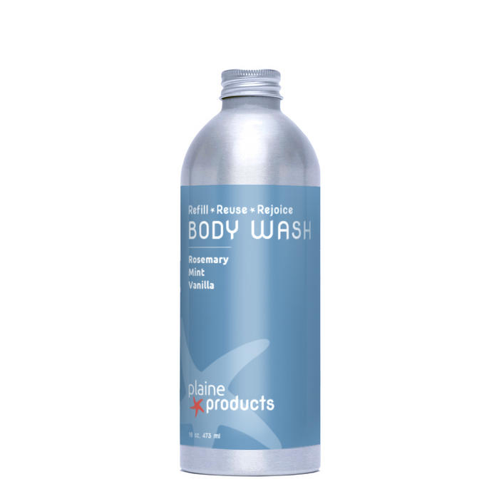 A silver Plaine Products bottle reads “BODY WASH” and “Rosemary Mint Vanilla,” featuring the brand’s zero-waste message: “Refill • Reuse • Rejoice.”.