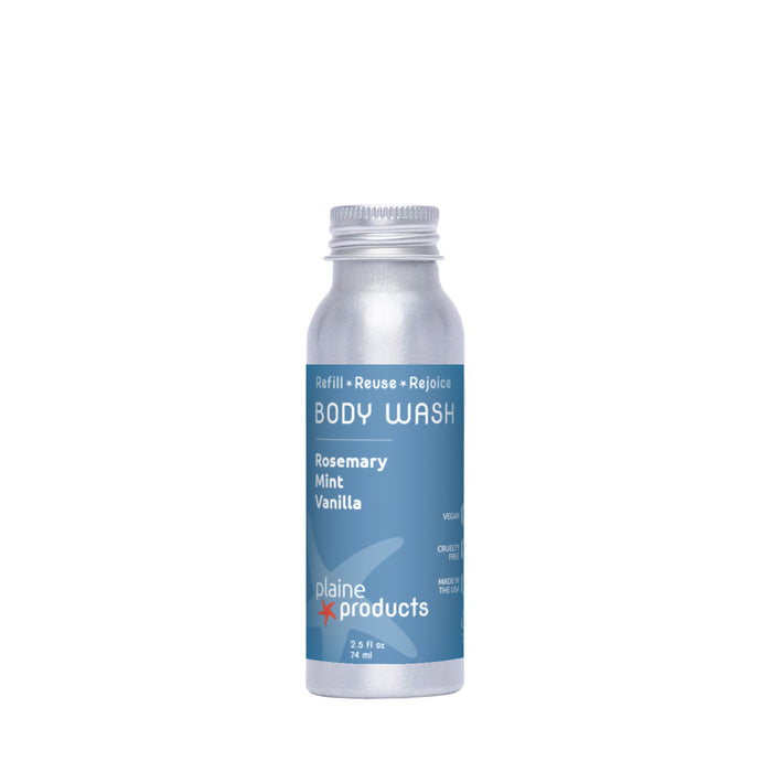 A small silver aluminum bottle of Plaine Products Body Wash, Rosemary Mint Vanilla scent, with blue label and white text, stands upright on a white background.