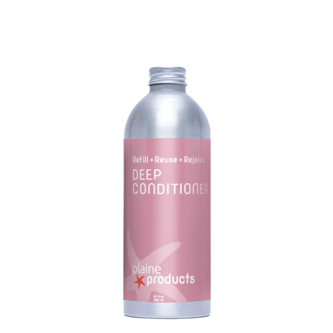 A silver aluminum bottle with a pink label reads “Deep Conditioner” by Plaine Products. At the top: “Refill • Reuse • Rejoice.” This hair moisturizer restores shine for healthy, vibrant hair.