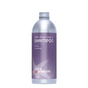 A silver bottle of Plaine Products Shampoo, Citrus Lavender, features a purple label with "Refill • Reuse • Rejoice," the brand name, an abstract starfish graphic, and claims to provide hair hydration.