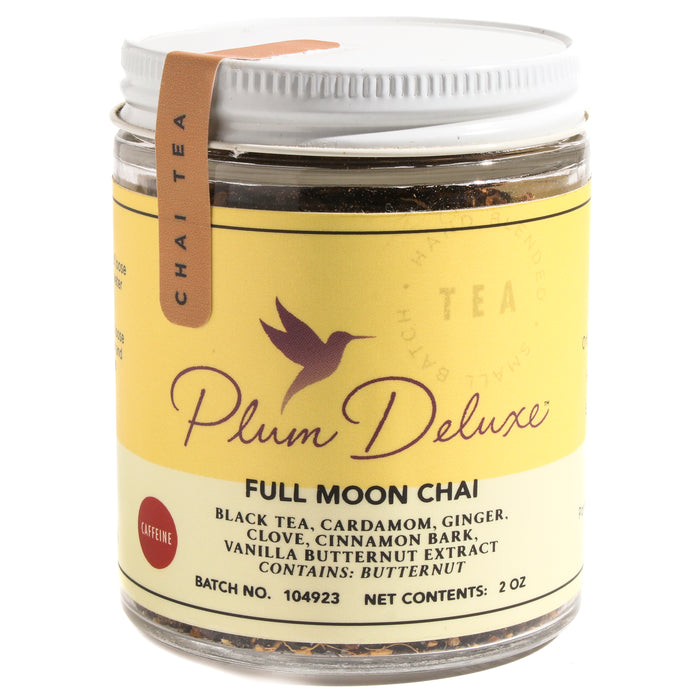 A 2 oz jar of Plum Deluxe Full Moon Chai Vanilla Butternut Masala Tea has a yellow label listing black tea, cardamom, ginger, clove, cinnamon, and vanilla butternut extract for a unique masala chai blend.