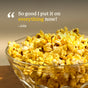 A clear glass bowl filled with yellow, buttery popcorn sits on a brown surface. Text above the bowl says, So good I put it on everything now! -Jolie with “everything” highlighted in yellow. The irresistible flavor comes from Diaspora Spice Co.’s Popcorn Seasoning made with single-origin spices and nutritional yeast, elevating every bite.