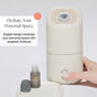 A hand presses a button on a sleek, beige Canopy Portable Humidifier. Nearby are a small essential oil bottle, its cap, and a tray. Text reads: “Hydrate Your Space—Angled design targets skin with moisture for personal comfort.”.