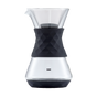 The SAKI Pour-Over Glass Coffee Maker showcases a sleek, clear glass design with a black textured silicone grip at the center and a robust stainless-steel mesh filter inside. The SAKI logo is displayed on the lower part of the glass, making this coffee maker both stylish and highly functional.
