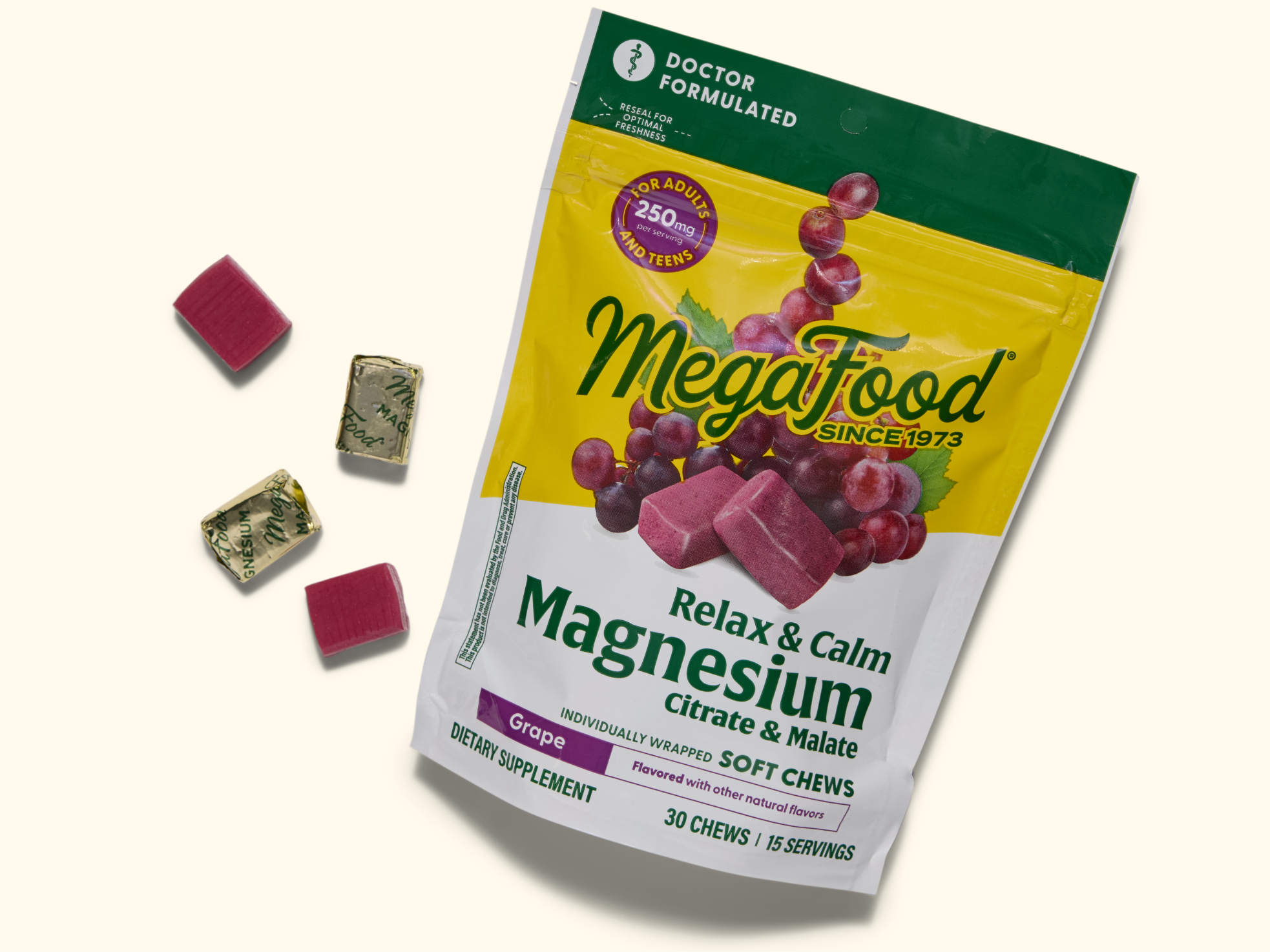 A bag of MegaFood Relax & Calm Magnesium Citrate & Malate Grape Soft Chews, with the package partially open and several individually wrapped chews and unwrapped purple chews placed beside it.