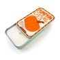 A rectangular Soy Wax Candle by The Neighborgoods in a reusable tin with a lid featuring a pumpkin illustration, the text Pumpkin Candle, and fragrance notes of warm pumpkin spice with a hint of vanilla.