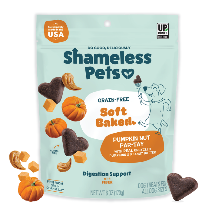 A bag of Shameless Pets Pumpkin Nut Par-Tay Soft-Baked Dog Treats features heart-shaped treats, pumpkin pieces, a cartoon dog with a fork, and highlights upcycled ingredients, fiber content, and digestion support on the packaging.
