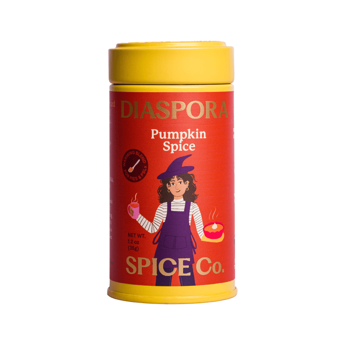 A yellow and red Diaspora Spice Co. Pumpkin Spice Blend container features an illustration of a person in purple overalls holding a pumpkin and a pastry on the front label, showcasing their single-origin spices in this aromatic blend.