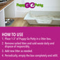 A box of Puppy Go Potty Potty Natural Paper Fiber Dog Litter sits on a wood floor by pet bowls. The brand appears above, with four-step usage instructions shown on a purple background.