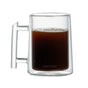 A clear double-walled glass mug with a handle from the Pure Over Double-Walled Mug Set (Set of 2), partially filled with black coffee and featuring the PURE|OVER logo etched near the base, sits on a plain white background.