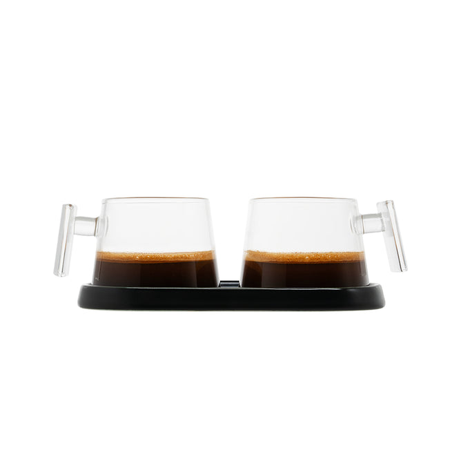A set of two Pure Over Espresso Cups (3.5 oz), each with a handle and filled with espresso, are displayed side by side on a black tray against a white background.