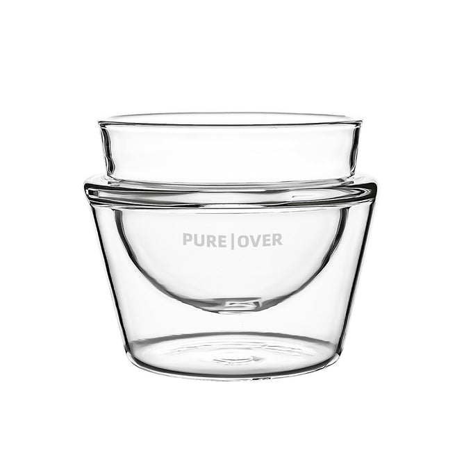 A transparent double-walled borosilicate glass Cortado Cup (5 oz) by Pure Over, featuring the brand name printed on the side, is shown against a plain white background.