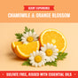 Sliced oranges and chamomile flowers with green leaves on an orange backdrop. Text: Scent Experience—Chamomile & Orange Blossom. Rebel Green Gentle Baby Laundry Detergent Liquid, 3x concentrated, sulfate free, organic, and gently scented with essential oils.