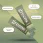 Two green sachets labeled Rookie Wellness Greens + Superfood float on a soft green background. Text highlights daily benefits: probiotics for gut health, stress and mood support, immune boost, and third-party testing.