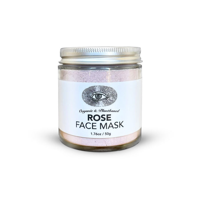 Anima Mundi’s ROSE Face Mask, Detoxify + Hydrate, comes in a 1.7 oz (50g) clear glass jar with a silver lid and white label featuring an eye illustration. This organic, handcrafted pink clay mask hydrates skin.
