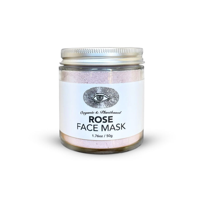 Anima Mundi’s ROSE Face Mask, Detoxify + Hydrate, comes in a 1.7 oz (50g) clear glass jar with a silver lid and white label featuring an eye illustration. This organic, handcrafted pink clay mask hydrates skin.