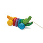 The PlanToys Rainbow Alligator is a colorful pull toy with segmented rainbow body parts that encourages gross motor skills. Made from sustainable wood, it features a front string and is beautifully designed for eco-friendly play.
