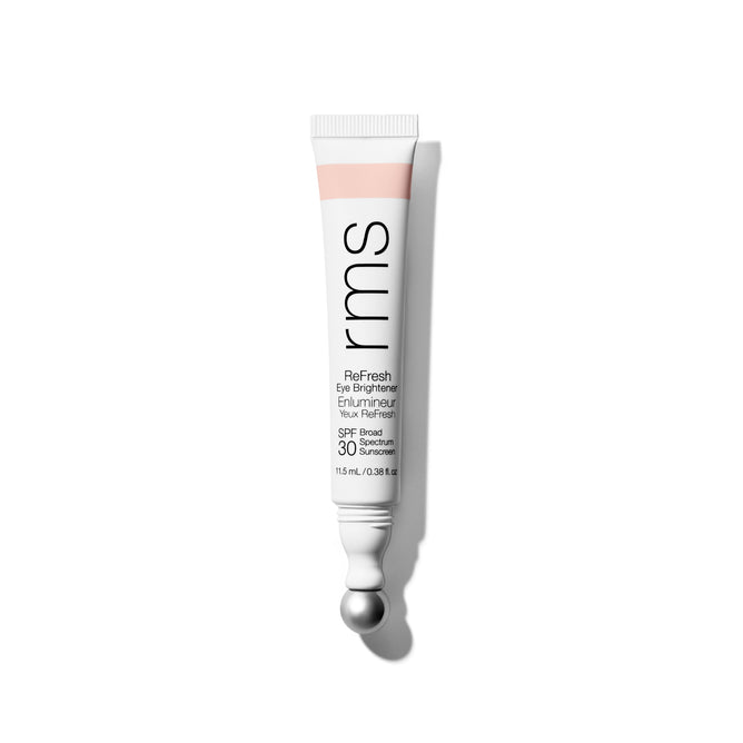 A white tube of RMS Beauty ReFresh Eye Brightener Broad Spectrum SPF 30, with a silver rollerball applicator and black text, stands upright against a plain white background.