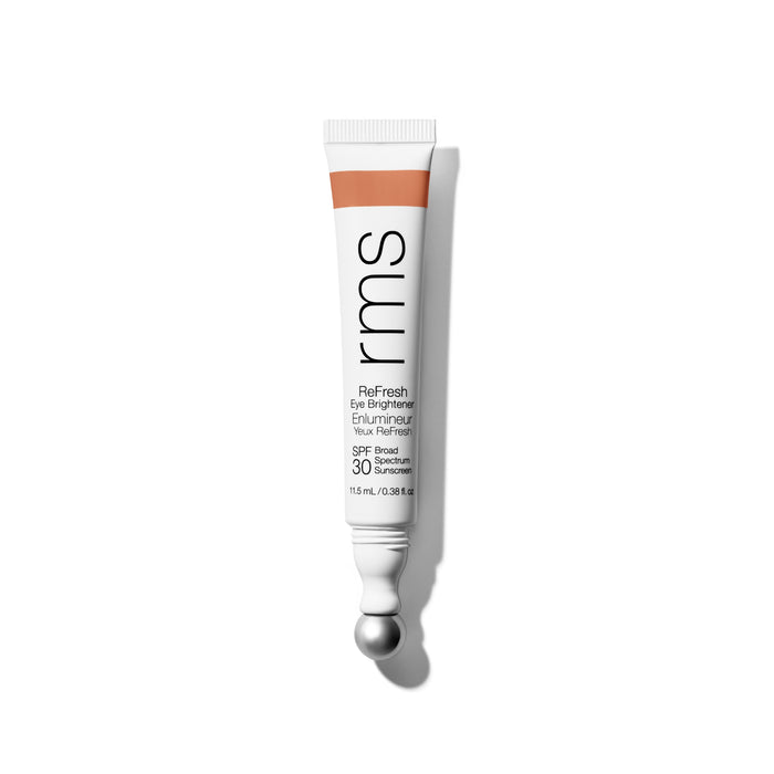 A white tube of RMS Beauty ReFresh Eye Brightener Broad Spectrum SPF 30 with mineral sunscreen, silver applicator tip, and orange accent on the cap stands upright against a plain white background.