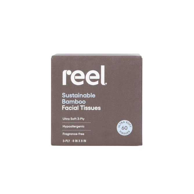 A brown box of Reel Premium Bamboo Facial Tissues contains 60 ultra-soft, 3-ply, hypoallergenic, fragrance-free tissues and features white text on the packaging.