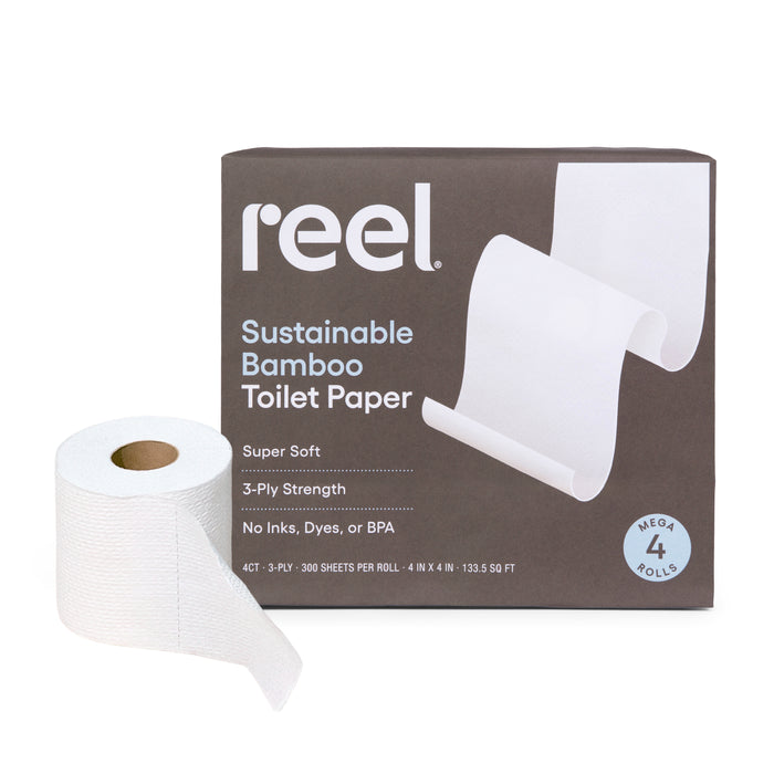 A roll of Reel Premium Bamboo Toilet Paper - 300 3-ply sheets per roll is shown beside its box, which highlights tree-free, septic-safe features, and states it's super soft with no inks, dyes, or BPA.