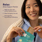 A smiling woman holds a Relax Stress Support Patch pulled from its packaging, with text overlay detailing its benefits and ashwagandha ingredients.