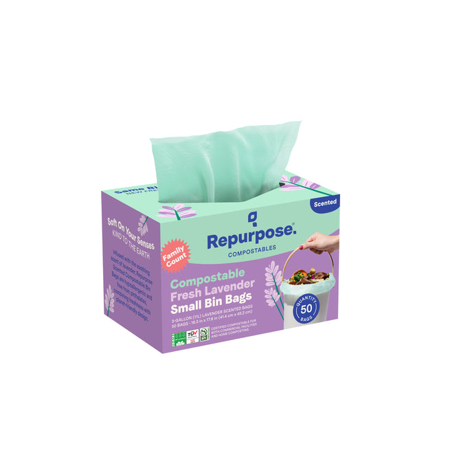 A box of Repurpose Compostable Small Bin Bags, Lavender Scented, with a green bag visible. The package contains 50 eco-friendly, home-compostable trash bags featuring a pleasant lavender scent.