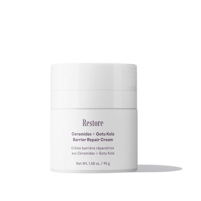 A white jar of Three Ships Restore Ceramides + Gotu Kola Barrier Repair Cream sits on a white surface, highlighting its moisture-boosting formula for sensitive skin in English and French. Net weight: 1.58 oz (45 g).