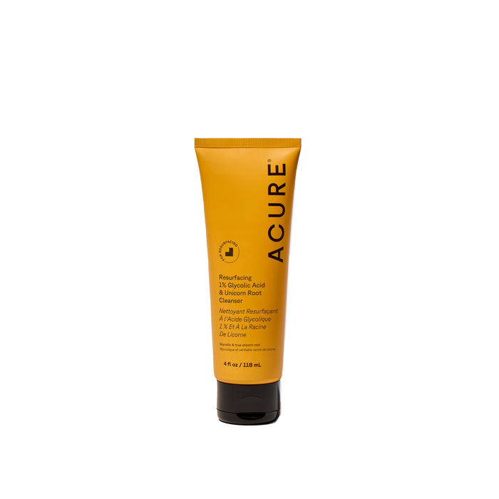 Mustard yellow squeeze tube of Acure Resurfacing 1% Glycolic Acid & Unicorn Root Cleanser with a black flip-top cap.