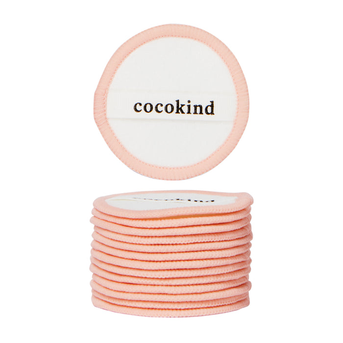 A stack of Cocokind Reusable Cotton Pads with light pink edges; the top pad, shown separately above, features cocokind printed in black on a white background.