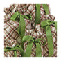 Five gifts, each presented in Waste Free Celebrations’ Reusable Gift Bags Set made from 100% cotton with a brown and green plaid design, are arranged closely together on a white background. Every bag is finished with a large green satin ribbon bow for an elegant, sustainable touch.