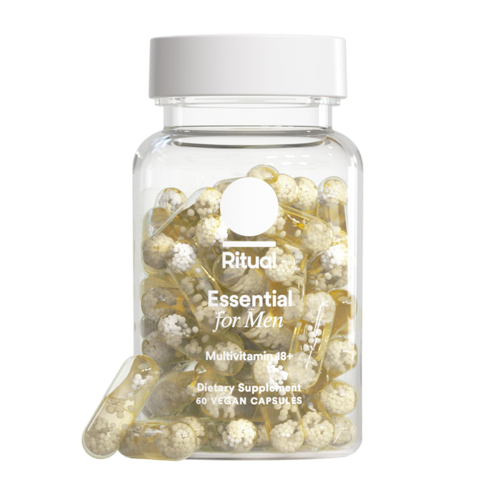 A clear Ritual Men's Multivitamin 18+ bottle holds 60 yellow and white vegan capsules with omega-3 DHA, shown open with two capsules in front—specially formulated for men.