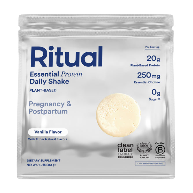 A pouch of Ritual Essential Protein Daily Natal, a plant-based vanilla protein powder for pregnancy and postpartum. Silver packaging shows 20g protein, 250mg choline, 0g sugar, and certification badges.