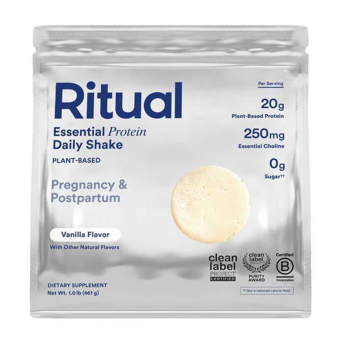 A pouch of Ritual Essential Protein Daily Natal, a plant-based vanilla protein powder for pregnancy and postpartum. Silver packaging shows 20g protein, 250mg choline, 0g sugar, and certification badges.