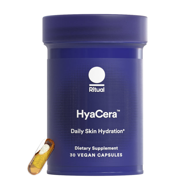 A purple cylindrical container labeled Ritual HyaCera, containing 30 vegan capsules, is shown with a single transparent capsule filled with yellow and white powder. Clinically proven to reduce wrinkles and improve skin smoothness.