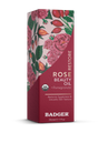 A 29.6ml (1 fl oz) box of Badger Balm Rose Beauty Oil - Restores & Smooths, formulated with organic rose oil and pomegranate for enhanced skin hydration. The packaging features rose and pomegranate illustrations, along with text highlighting its ability to restore suppleness and smooth skin texture.