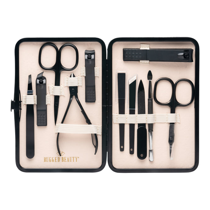 The Rugged Beauty 11-in-1 Manicure Set includes premium black nail care tools—scissors, clippers, tweezers, files, and cuticle tools—neatly organized in a beige case.