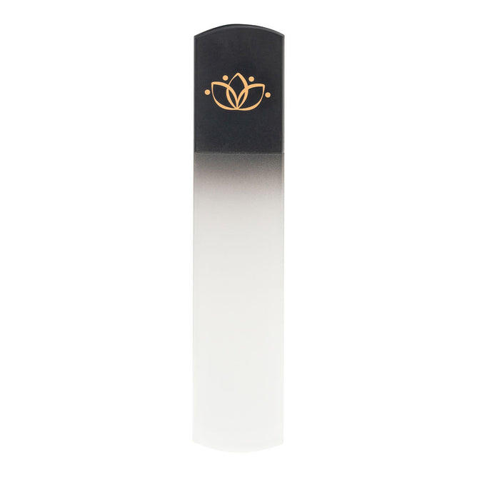 The Lotus Glass Nail File by Rugged Beauty features a black top with a gold lotus flower design that transitions to clear at the base. Ideal for any manicure or nail kit, it stands upright against a white background.