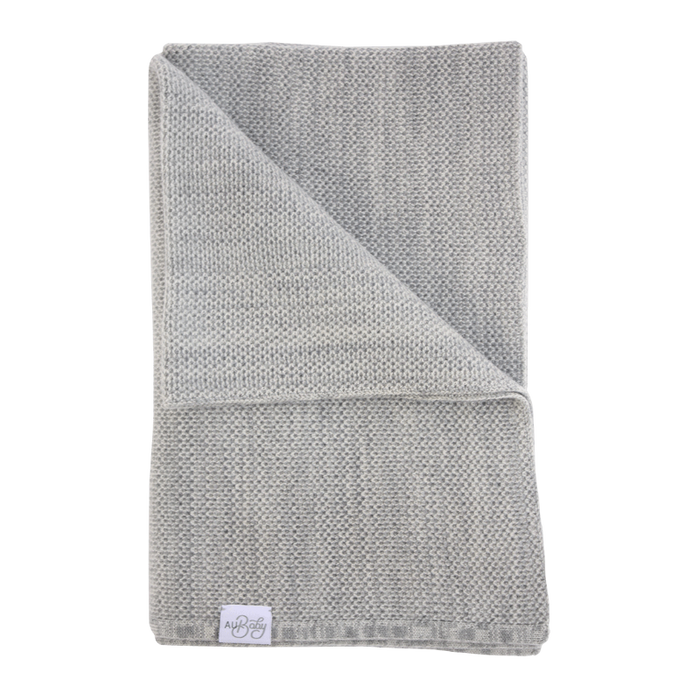 The Sawa - Moon Stone light gray merino baby blanket folded over itself.
