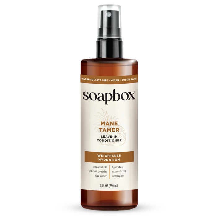 The 8 fl oz Soapbox Mane Tamer Leave-In Conditioner, featuring a spray nozzle, provides frizz-free, weightless hydration. Its sulfate-free, vegan, and color-safe and infused with coconut oil and quinoa protein for smooth hair.