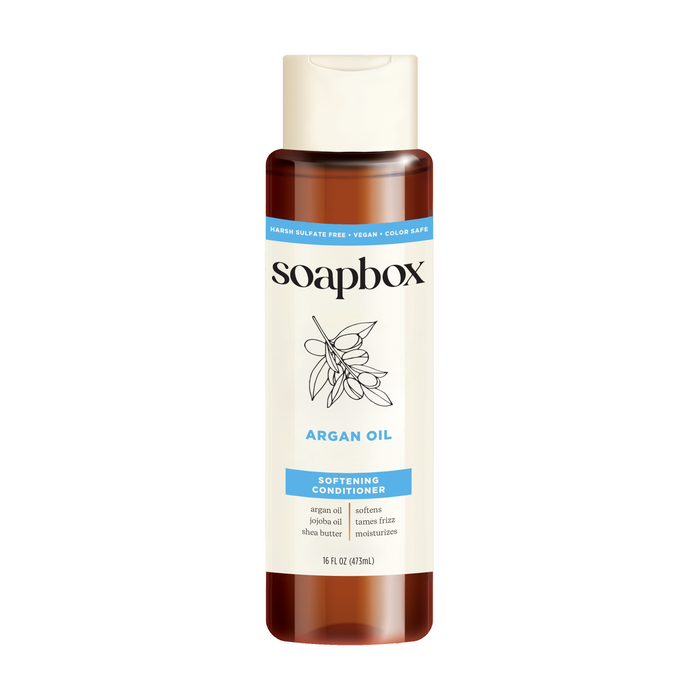 Experience the nourishing power of Soapbox Argan Oil Softening Conditioner in a 16 fl oz (473 ml) brown bottle with a white argan nut label. This sulfate-free, vegan formula is enriched with shea butter and a vitamin complex for color-safe moisture.