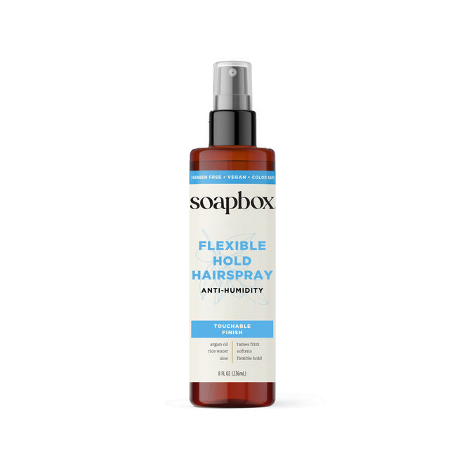 Soapbox Flexible Hold Hairspray, 8 fl oz (236 ml), offers anti-humidity, frizz-taming argan oil for touchable, brushable hold. The brown bottle has a gray cap and a blue and white label.