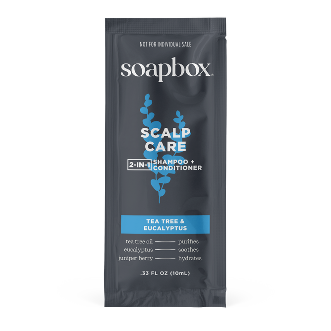 The Soapbox Scalp Care 2-in-1 - Sample delivers a nourishing cleanse with an invigorating scent, featuring tea tree and eucalyptus. The dark sachet, accented by white and light blue text, contains 0.33 fl oz (10 mL).