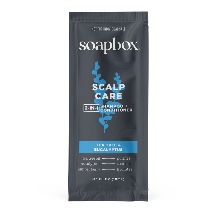 The Soapbox Scalp Care 2-in-1 - Sample delivers a nourishing cleanse with an invigorating scent, featuring tea tree and eucalyptus. The dark sachet, accented by white and light blue text, contains 0.33 fl oz (10 mL).