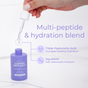 A hand holds a dropper above a purple Tree To Tub Copper Peptides Face Serum bottle, featuring Multi-Peptides, Triple Hyaluronic Acid for hydration, and Squalane for moisture. The lightweight serum is dispensed for enhanced skin care.