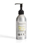 A silver aluminum Soap Distillery Hand + Body Wash bottle with a black pump and white label showing usage directions, recycling symbols, product info, and clear instructions on the back—perfect for hand or body cleansing.